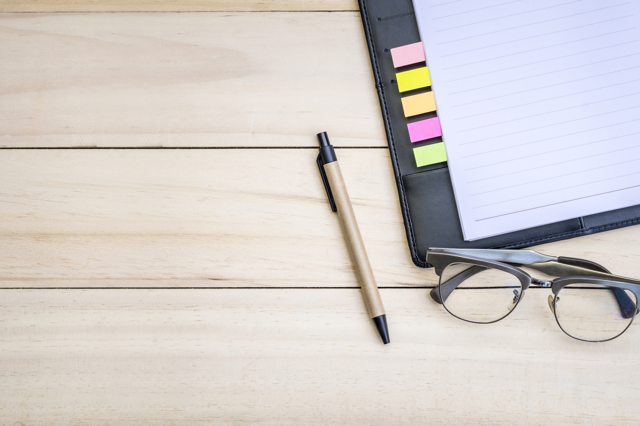 Relaxing after working, Modern office desk with pen eyeglass and blank notebook on wooden, Blank space for insert wording