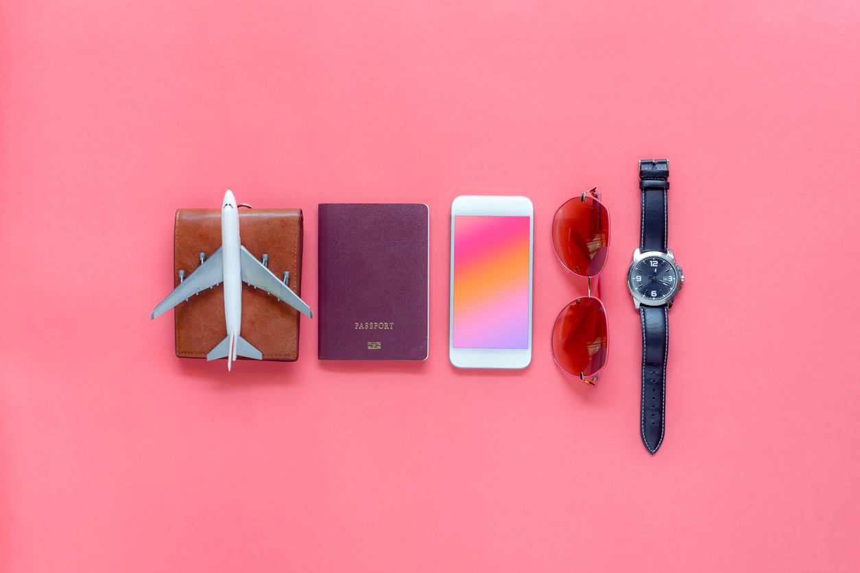 Flat lay image of accessory clothing man or women to plan travel in holiday background concept.Mobile phone &amp; passport with many item in vacation season.Table top view several object on pink paper.